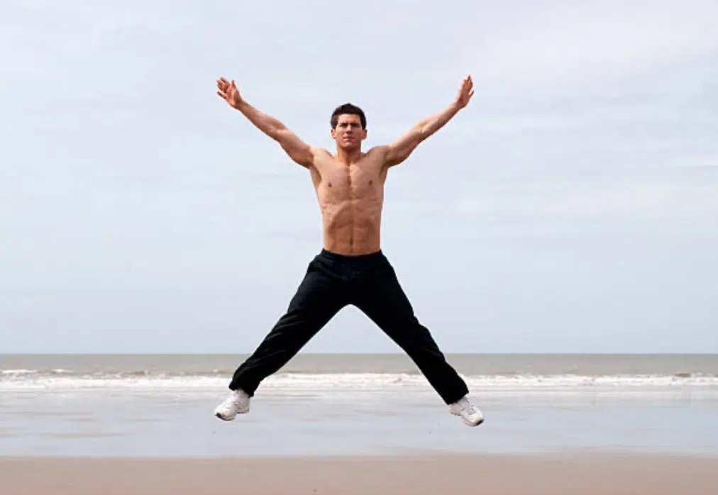 Man doing jumping jacks star jumps exercise Vector Image