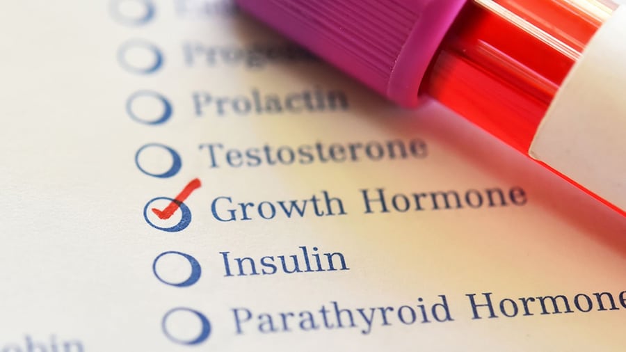 A vial of growth hormone in front of a checklist marked Growth Hormone.
