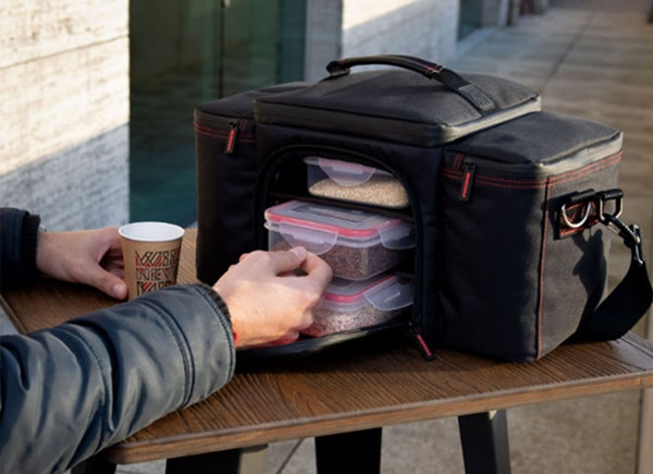 A man stores his workout meals in an insulated carry bag.
