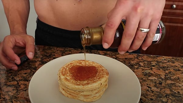 Sports coach Julien Quaglierini adds 0-calorie syrup to his protein pancake recipe.