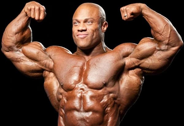 Shirtless bodybuilder Phil Heath posing at a bodybuilding competition.