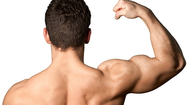 A shirtless man, from behind, contracting his right biceps.