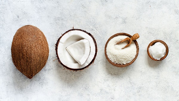 An image showing the manufacturing process of coconut flour, from the original coconut to the flour.